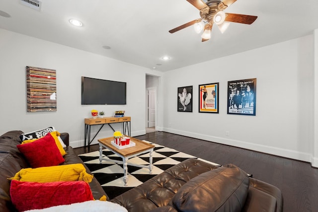 living room with dark wood-type flooring and ceiling fan