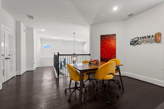 dining space with an inviting chandelier and dark hardwood / wood-style flooring