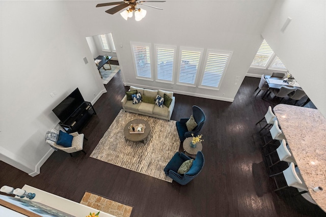 living room with ceiling fan and dark hardwood / wood-style floors