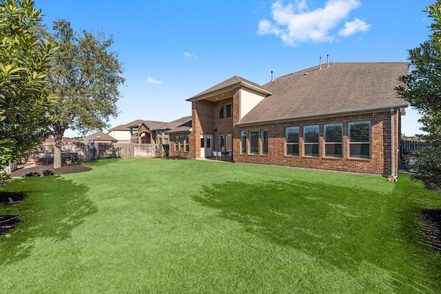 rear view of property featuring a yard