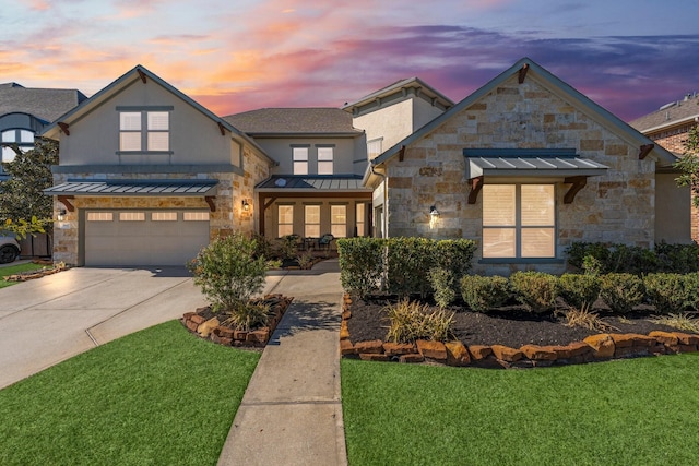 view of front facade with a garage and a yard