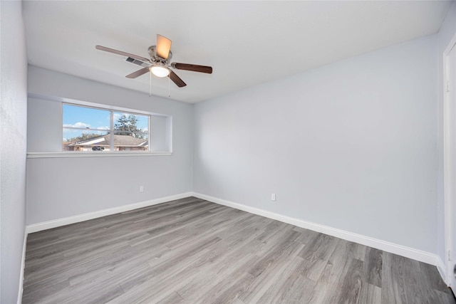 unfurnished room with ceiling fan and wood-type flooring