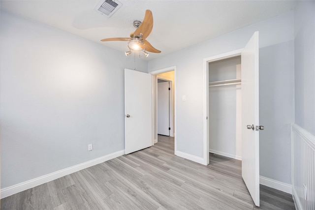 unfurnished bedroom with ceiling fan, light hardwood / wood-style floors, and a closet