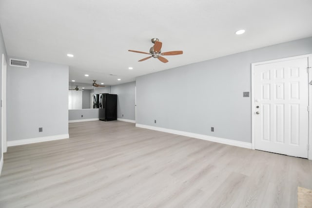 unfurnished living room with ceiling fan and light hardwood / wood-style flooring