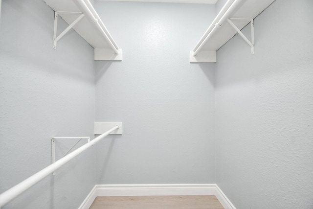 walk in closet featuring hardwood / wood-style floors