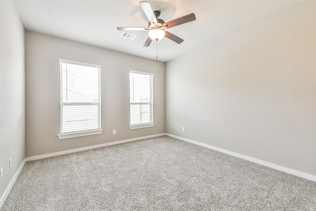 unfurnished room featuring ceiling fan and carpet flooring