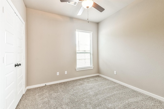 spare room with carpet floors and ceiling fan