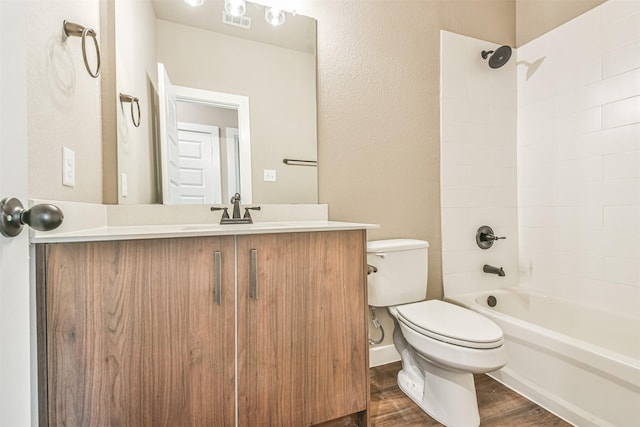 full bathroom with vanity, hardwood / wood-style flooring, bathtub / shower combination, and toilet