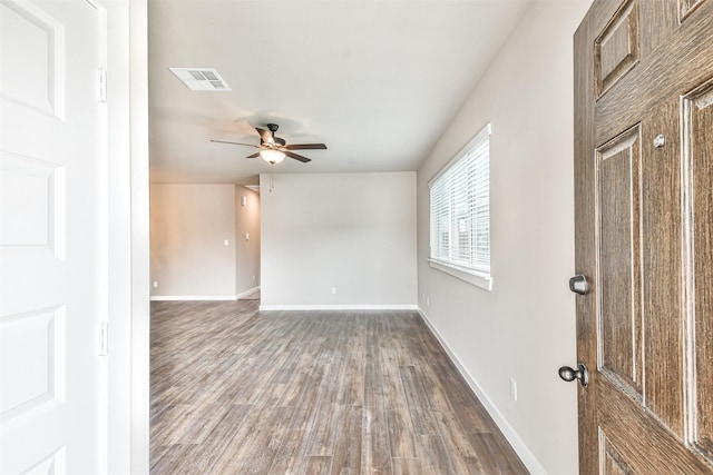 spare room with dark hardwood / wood-style floors and ceiling fan