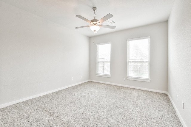 carpeted spare room with ceiling fan