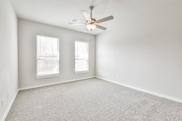 empty room featuring ceiling fan and carpet flooring