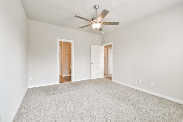 unfurnished bedroom featuring carpet floors, a spacious closet, ceiling fan, and a closet