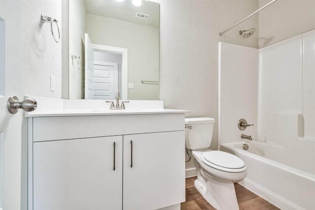 full bathroom featuring shower / bathing tub combination, vanity, wood-type flooring, and toilet