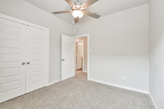 unfurnished bedroom featuring ceiling fan, light carpet, and a closet