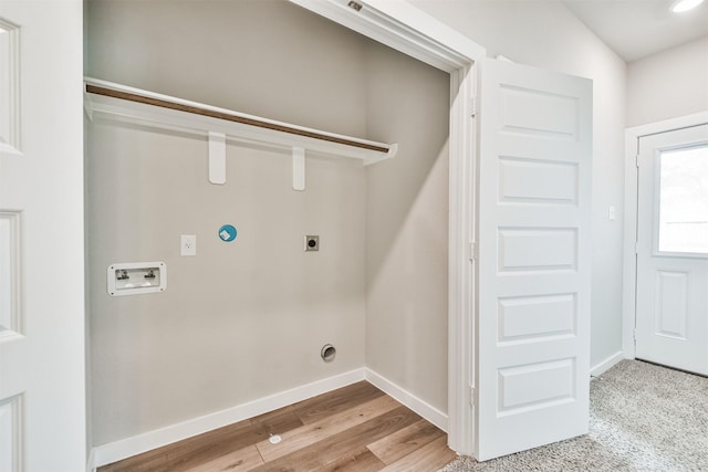 laundry area with gas dryer hookup, hookup for an electric dryer, light hardwood / wood-style floors, and hookup for a washing machine