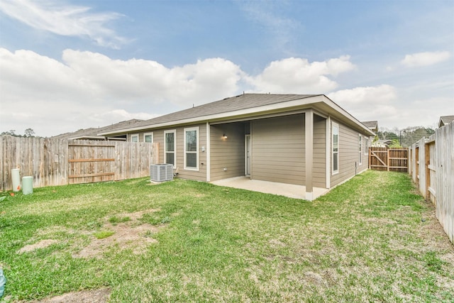 rear view of property with central AC, a patio area, and a lawn