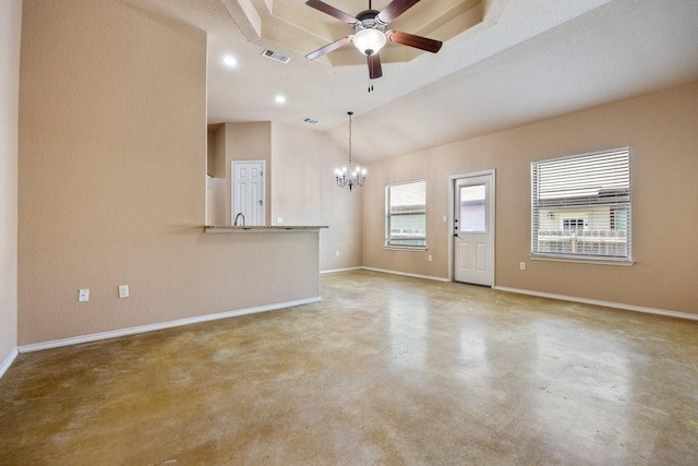 unfurnished living room with ceiling fan with notable chandelier, vaulted ceiling, and concrete floors