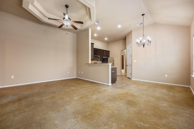 unfurnished living room with a tray ceiling and ceiling fan with notable chandelier