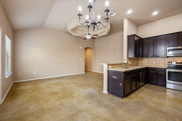 kitchen with dark brown cabinetry, appliances with stainless steel finishes, light stone countertops, and decorative backsplash