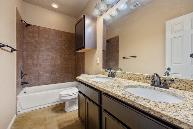 full bathroom with tiled shower / bath, vanity, and toilet