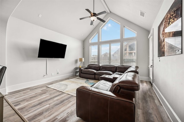 living room with hardwood / wood-style flooring, high vaulted ceiling, and ceiling fan