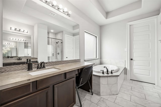 bathroom with a raised ceiling, plus walk in shower, and vanity