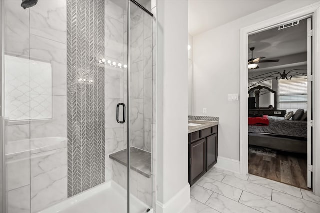 bathroom featuring vanity, a shower with shower door, and ceiling fan