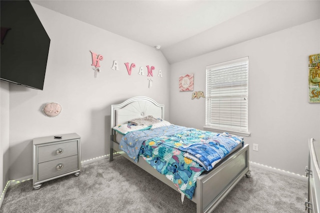 bedroom featuring light colored carpet and vaulted ceiling