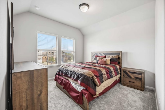 bedroom with lofted ceiling and light carpet