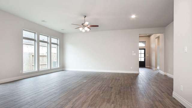 spare room with dark hardwood / wood-style flooring, plenty of natural light, and ceiling fan