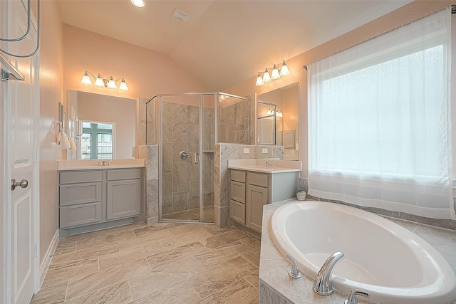 bathroom with lofted ceiling, separate shower and tub, and vanity