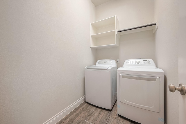 clothes washing area featuring hardwood / wood-style floors and independent washer and dryer