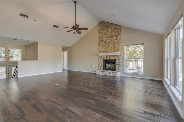 unfurnished living room featuring a fireplace, dark hardwood / wood-style flooring, and a wealth of natural light