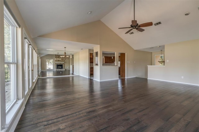 unfurnished living room featuring high vaulted ceiling, dark wood-type flooring, and ceiling fan