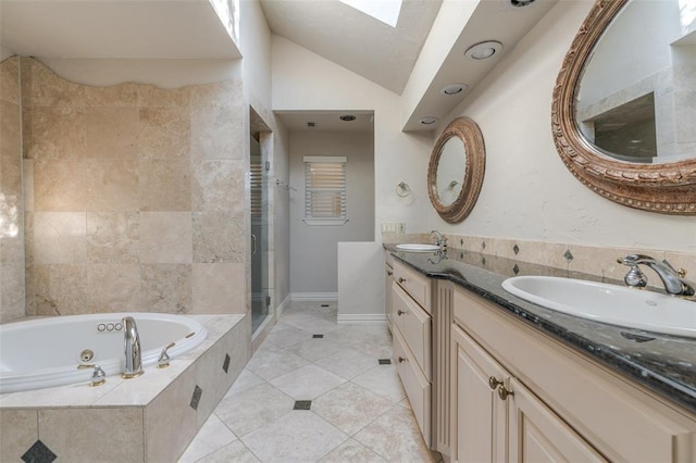 bathroom with vanity, lofted ceiling with skylight, tile patterned flooring, and shower with separate bathtub