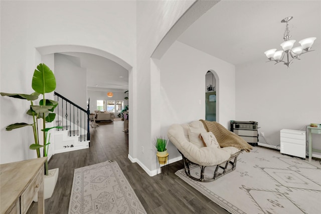 7 Calistoga Cir, Manvel, TX 77578 - living area with arched walkways, wood finished floors, stairway, and a chandelier