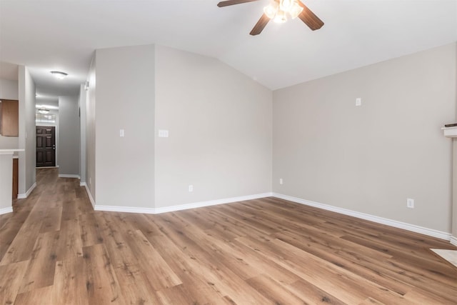 unfurnished living room featuring vaulted ceiling, light hardwood / wood-style floors, and ceiling fan