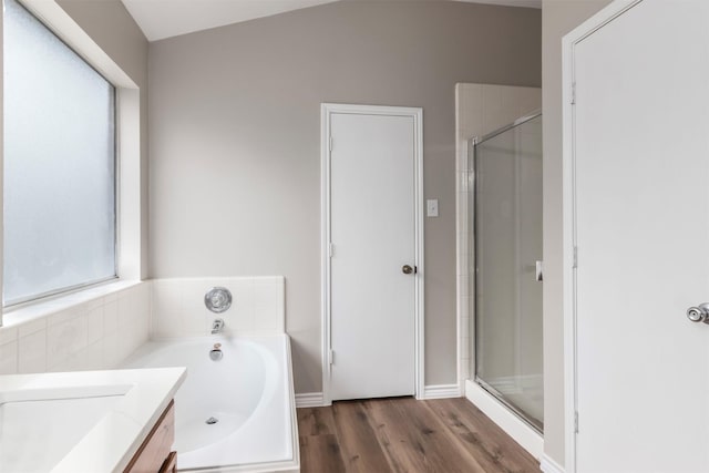 bathroom featuring vanity, separate shower and tub, and hardwood / wood-style floors