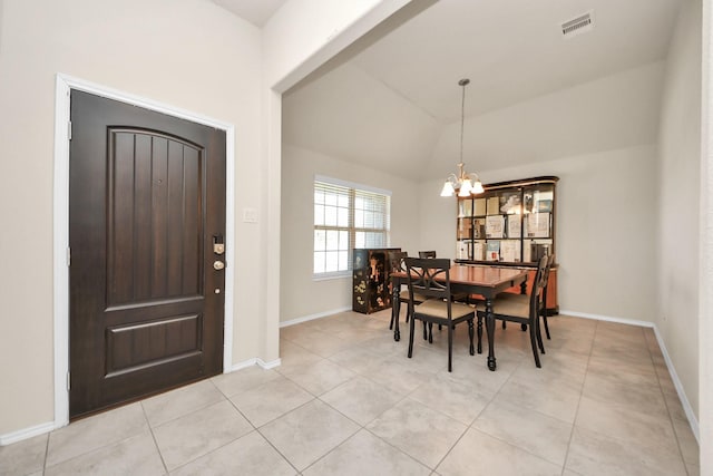 dining room featuring light tile patterned floors, vaulted ceiling, and a chandelier