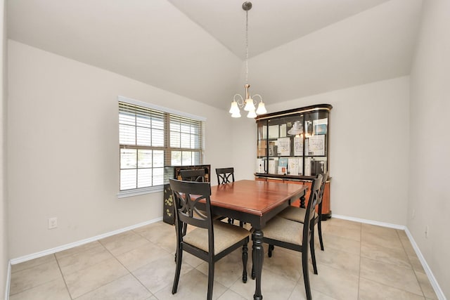 tiled dining room featuring lofted ceiling and an inviting chandelier