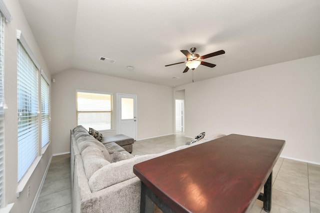 living room with lofted ceiling, light tile patterned floors, and ceiling fan