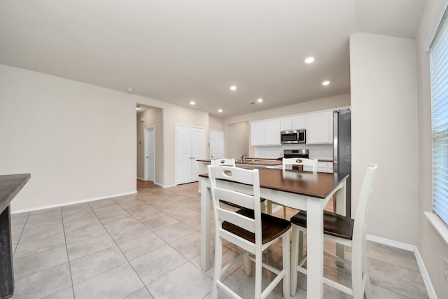 dining room with light tile patterned flooring