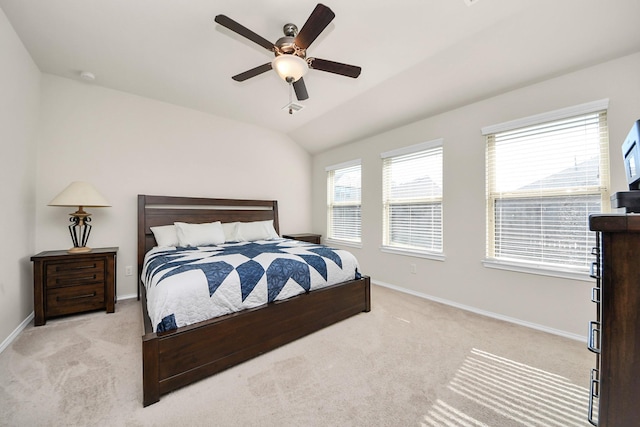 bedroom featuring ceiling fan, vaulted ceiling, and light carpet