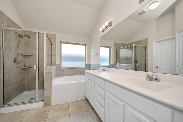 bathroom with independent shower and bath, vaulted ceiling, and tile patterned floors