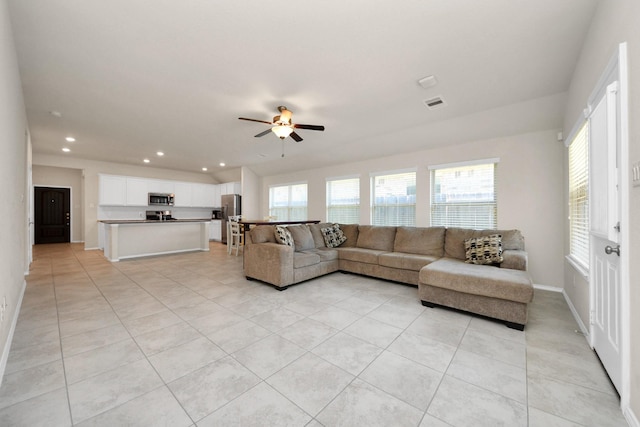 living room featuring light tile patterned floors and ceiling fan