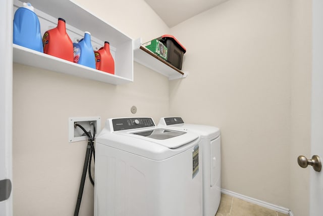 laundry room featuring light tile patterned floors and washing machine and dryer