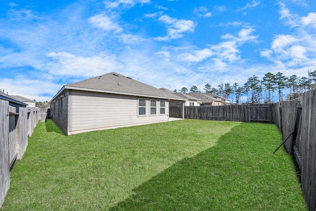 rear view of property with a yard