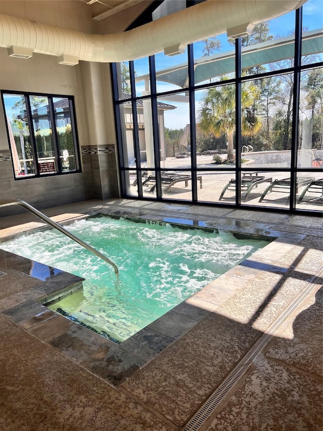 view of swimming pool featuring an indoor in ground hot tub