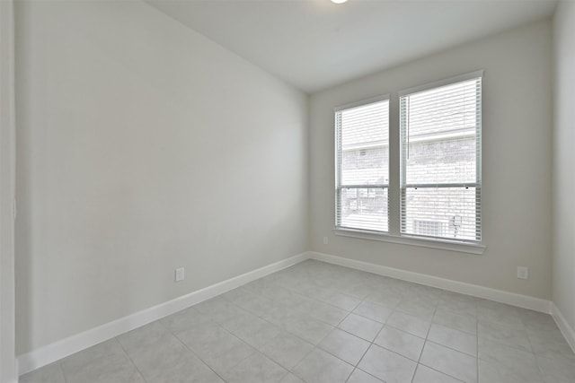 unfurnished room featuring light tile patterned flooring