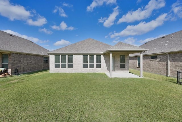 back of house with a patio area and a lawn